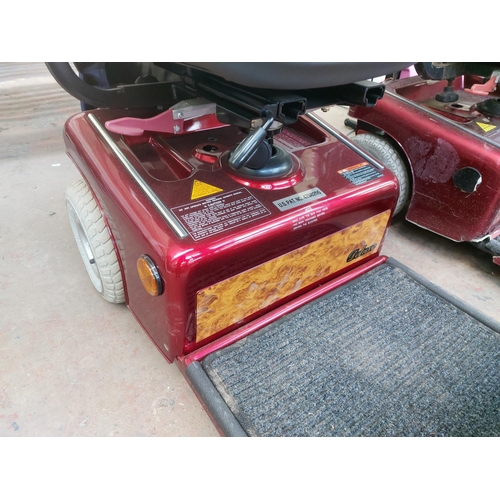 1209 - A red Shoprider Deluxe four wheeled mobility scooter with front shopping basket, instruction manual,... 