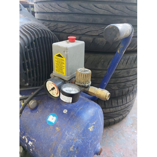 1245 - Three items, one blue oil free air compressor and two trolley jacks