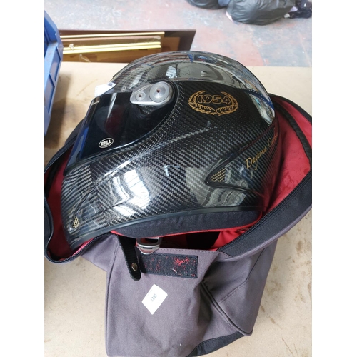 1260 - A bagged black Bell Helmets Daytona carbon motorcycle crash helmet with two visors