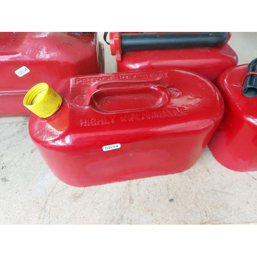 1267 - Four red metal petrol cans