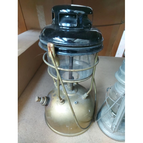 1269 - Four items, one Tornado storm lantern, one black enamel and gold Tilley paraffin lamp, one Meva stor... 