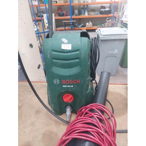 1286 - Two green Bosch electric power tools, one AQT33-10 pressure washer with hose and lance and one ALS30... 