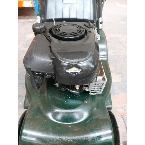 1359 - A black and green Hater Harrier 48 petrol lawn mower with Briggs & Stratton engine and grass collect... 