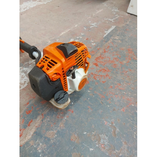 1380 - An orange and grey Stihl long reach petrol hedge trimmer with 20