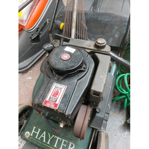 1386 - A mixed lot to include black and green Hater DVS153 petrol lawnmower with grass collector, garden ra... 