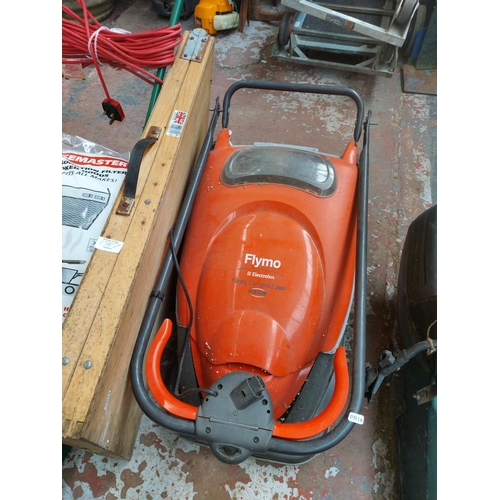 1387 - Four items, one orange and grey Flymo Electrolux Turbo Compact 380 Vison electric hover mower, one b... 