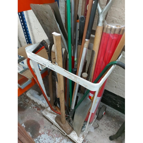 1412 - A mixed lot of gardening hand tools to include pick axe, ditching spade, shovel, rakes, brushes etc.... 