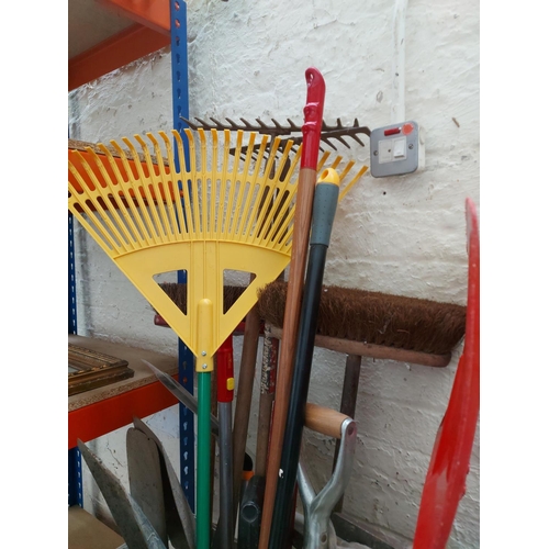 1412 - A mixed lot of gardening hand tools to include pick axe, ditching spade, shovel, rakes, brushes etc.... 