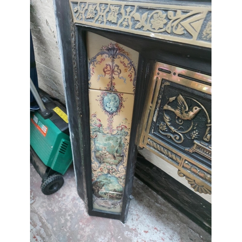 1416 - A cast iron fireplace insert with decorative tiles - approx. 38