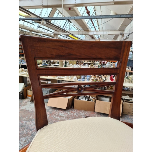 745 - A stained pine circular dining table and four chairs with white upholstered seats - approx. 147.5cm ... 