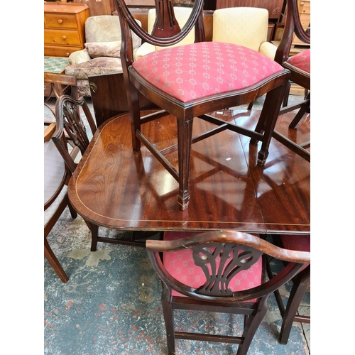 747 - A mahogany and rosewood effect extending dining table and twelve matching Hepplewhite style dining c... 