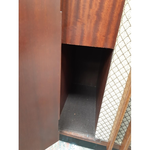 1127 - An empty mid 20th century figured mahogany radiogram cabinet on casters