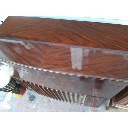 1127 - An empty mid 20th century figured mahogany radiogram cabinet on casters