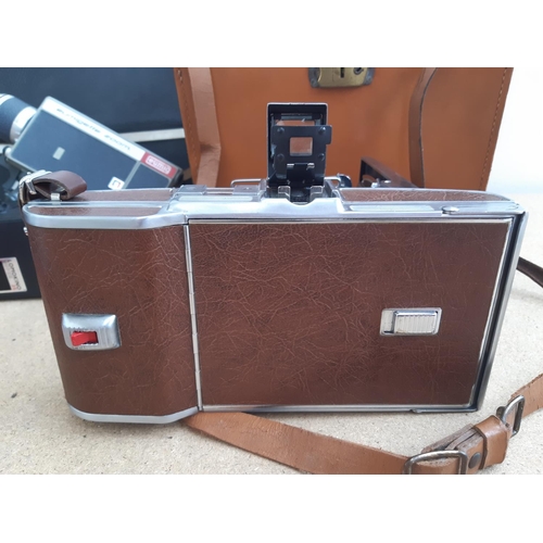 1190 - A box containing cameras and photography equipment to include cased Polaroid model 95B land camera, ... 