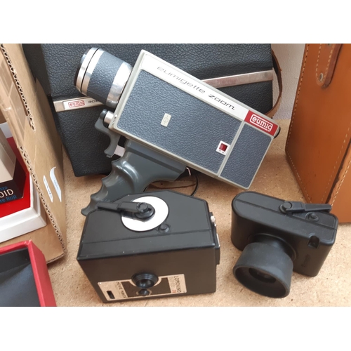 1190 - A box containing cameras and photography equipment to include cased Polaroid model 95B land camera, ... 