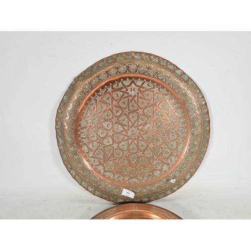 488 - Two Middle Eastern copper wall chargers - the largest approx. 45cm diameter