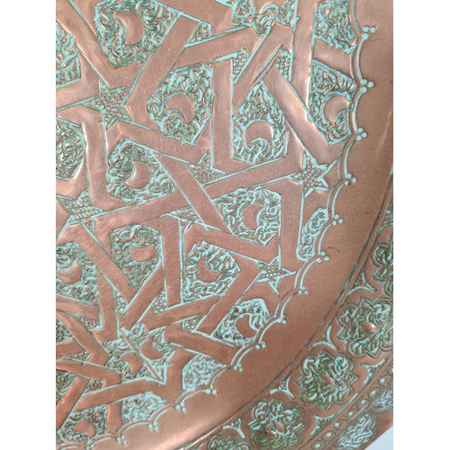 488 - Two Middle Eastern copper wall chargers - the largest approx. 45cm diameter