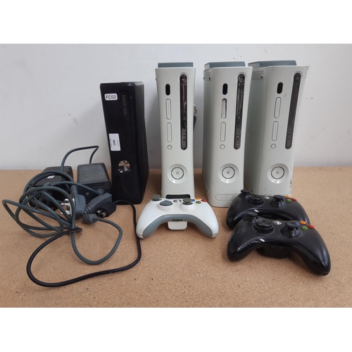 1080 - A box containing four Xbox 360 consoles, three original and one slimline with two power adapters and... 