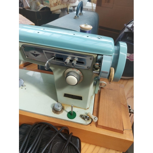 1136 - A cased vintage Brother blue and green enamel electric sewing machine with foot pedal