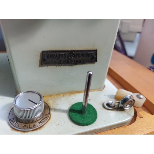 1136 - A cased vintage Brother blue and green enamel electric sewing machine with foot pedal