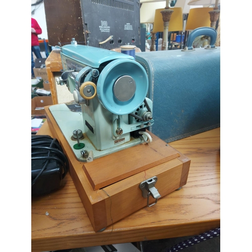 1136 - A cased vintage Brother blue and green enamel electric sewing machine with foot pedal