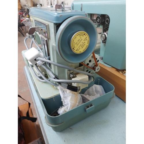 1137 - Two cased vintage electric sewing machines, one green and white Alfa and one blue and green Jones bo... 