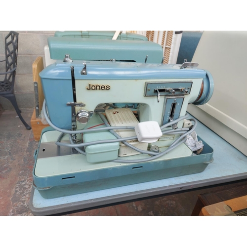 1137 - Two cased vintage electric sewing machines, one green and white Alfa and one blue and green Jones bo... 