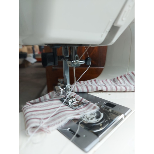 1138 - Two items, one white Janome Jem Gold electric sewing machine and one wooden box containing cotton an... 