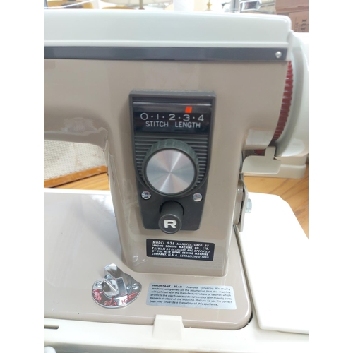 1139 - A cased vintage brown and grey New Home model 535 electric sewing machine with foot pedal