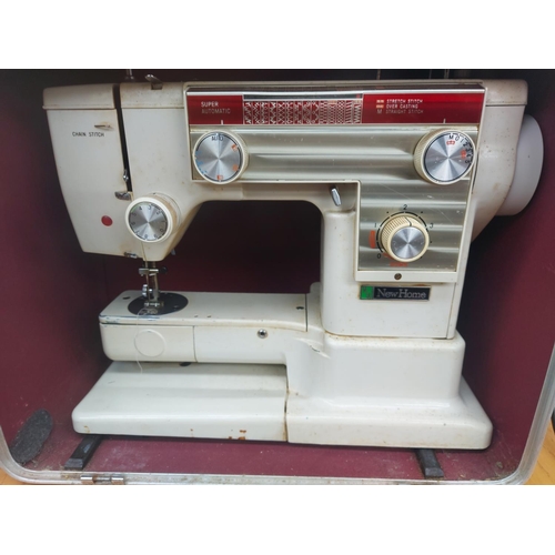 1141 - Two items, one cased vintage white New Home electric sewing machine with foot pedal and one box cont... 