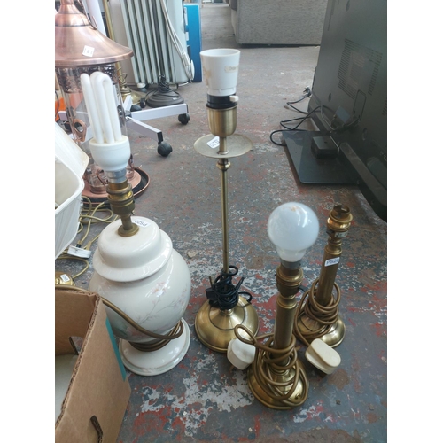 1150 - A large lighting lot to include brushed brass triple standard lamp, brass and porcelain table lamps ... 