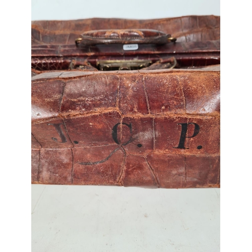 614 - An early 20th century crocodile skin gladstone bag monogrammed 'J. C. P.'