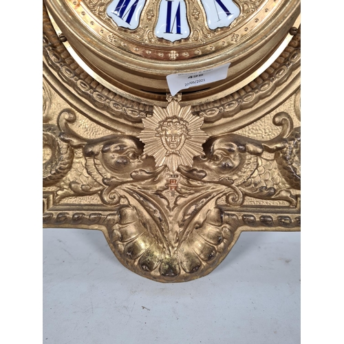 498 - A Victorian wood and gilt metal wall clock with white and blue enamel Roman numerals, key and pendul... 