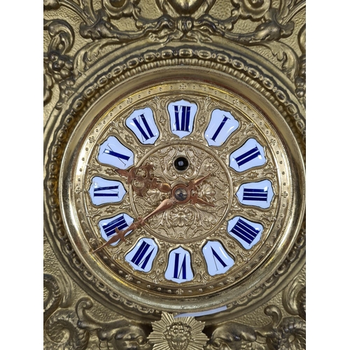 498 - A Victorian wood and gilt metal wall clock with white and blue enamel Roman numerals, key and pendul... 