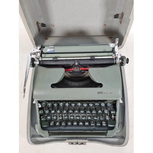 510 - A vintage cased green metal Olympia typewriter