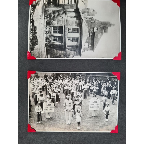 532 - A photo album containing a large collection of black & white photographs and postcards of old town L... 