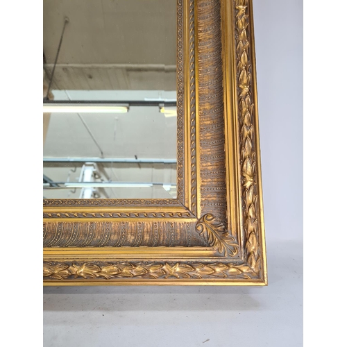 565 - A 19th century style ornate gilt framed bevelled edge rectangular wall mirror - approx. 113cm x 82cm