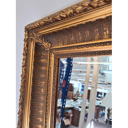 565 - A 19th century style ornate gilt framed bevelled edge rectangular wall mirror - approx. 113cm x 82cm