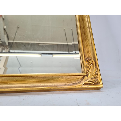 579 - A modern gilt framed bevelled edge wall mirror - approx. 90cm x 70cm