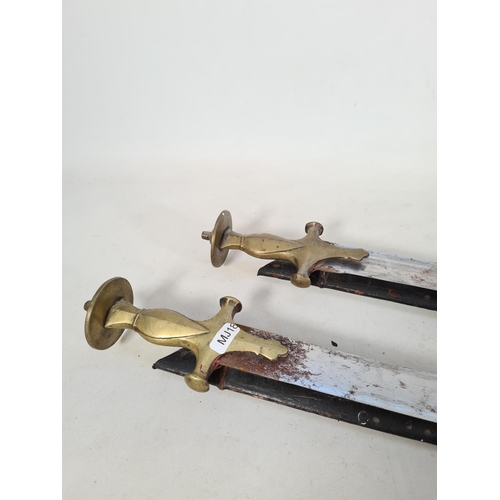 603 - A pair of 19th century Indian tulwar swords with solid brass hilts each complete with wood and fabri... 