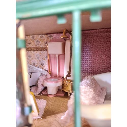 620 - A vintage hand painted two storey dolls house with a large quantity of furniture and accessories