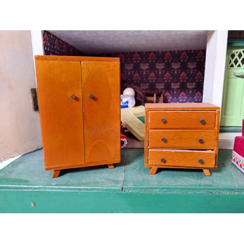 620 - A vintage hand painted two storey dolls house with a large quantity of furniture and accessories