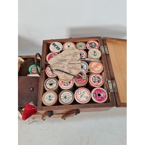 629 - A vintage oak cantilever sewing box with contents