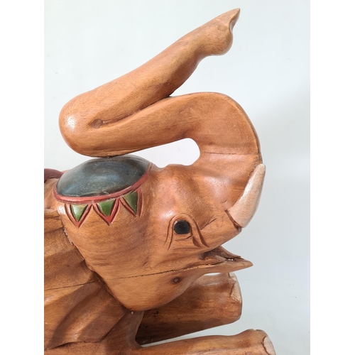 634 - A modern carved wooden elephant child's rocking seat