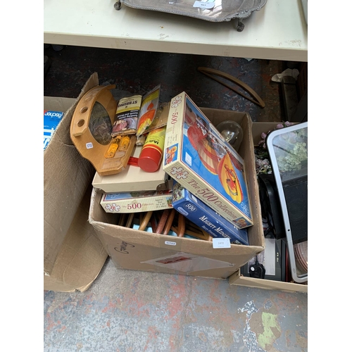 1472 - Two boxes containing vintage jigsaw puzzles, Monopoly board game, boxe set of four Walt Disney books... 