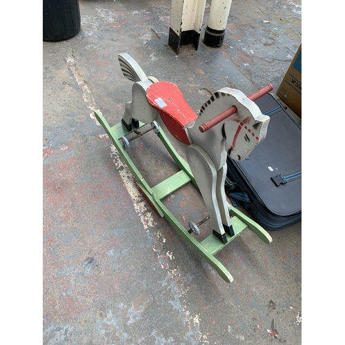 1480 - One vintage wooden rocking horse and one suitcase containing vintage items to include brass darts, f... 