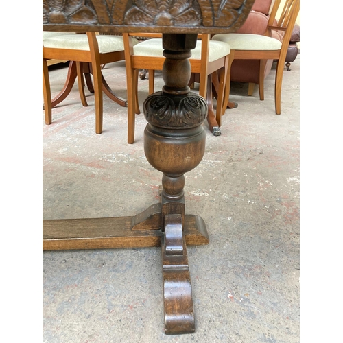 673 - An 18th century style oak draw leaf dining table on baluster supports - approx. 76cm high x 182cm lo... 