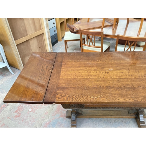 673 - An 18th century style oak draw leaf dining table on baluster supports - approx. 76cm high x 182cm lo... 