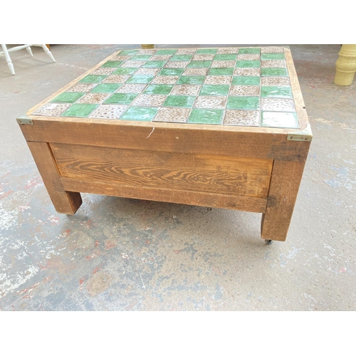 740 - A pine and tile top square chess board/coffee table with campaign style handles and chess pieces - a... 