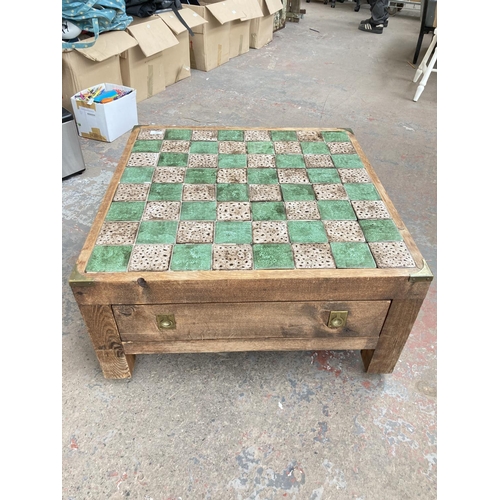 740 - A pine and tile top square chess board/coffee table with campaign style handles and chess pieces - a... 